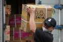 A worker carries a box of supplies for a Mixue store in Jakarta, Indonesia, Wednesday, February 19,…