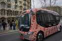 A driverless mini-bus, presented by WeRide and Renault Group, drives by Casa Batlló, designed by An…